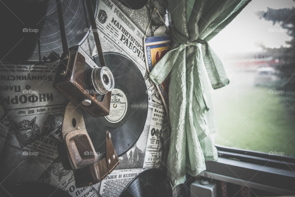 Old vinyls, newspapers and camera on the wall