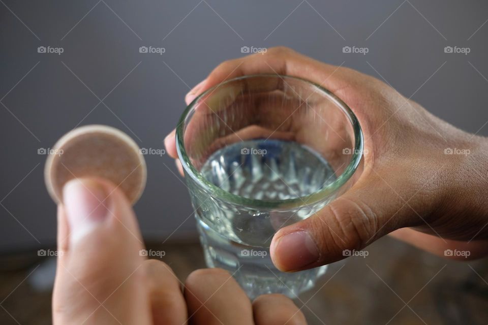 Glass of water with tablet