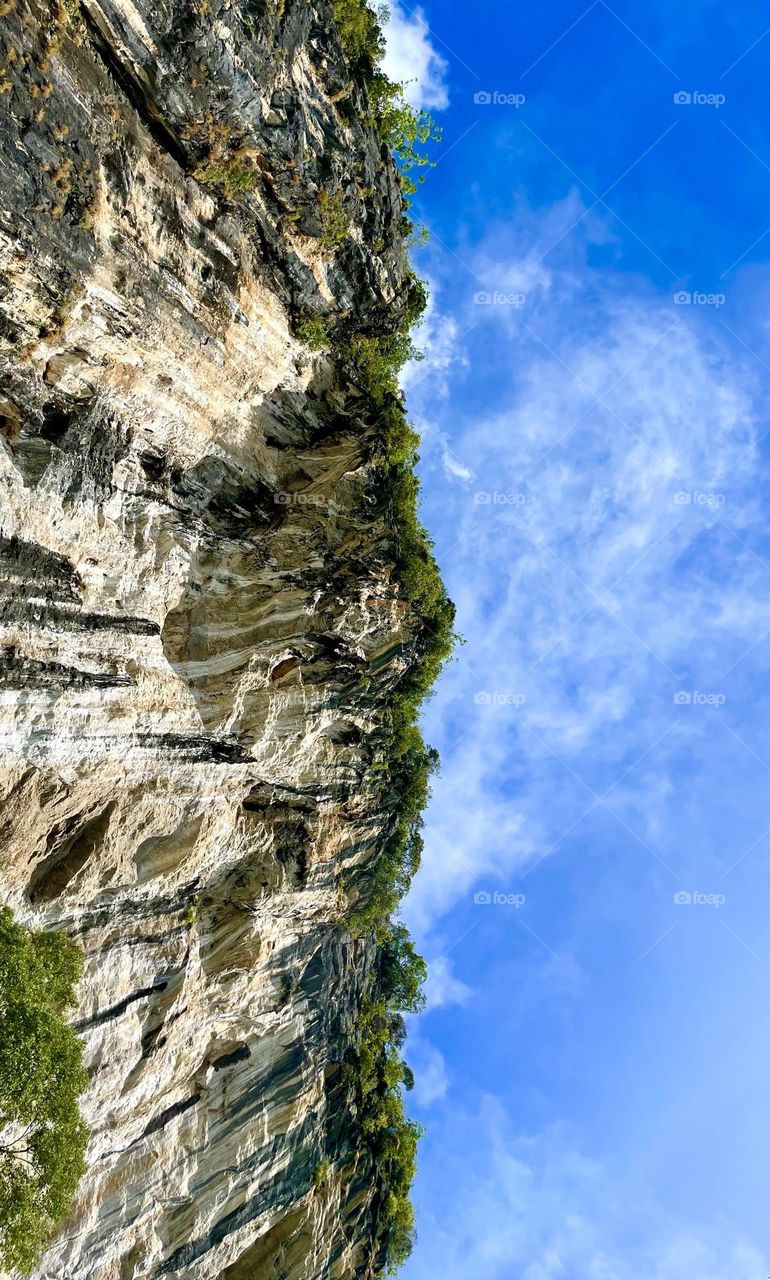 Another angle of seeing from ground to top for island in Krabi, Thailand. Contrasting between cliffs and sky is such amazing of nature.
