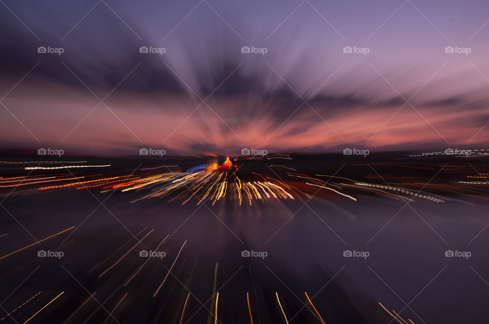 sunset zoom burst over land and sea