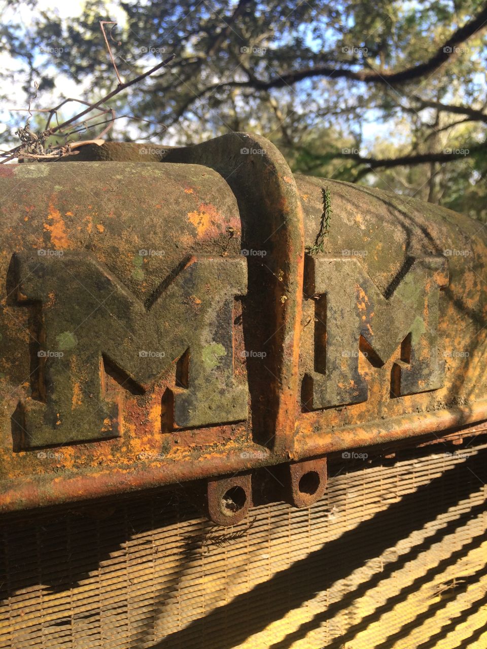 Abandoned antique Minneapolis Moline tractor logo