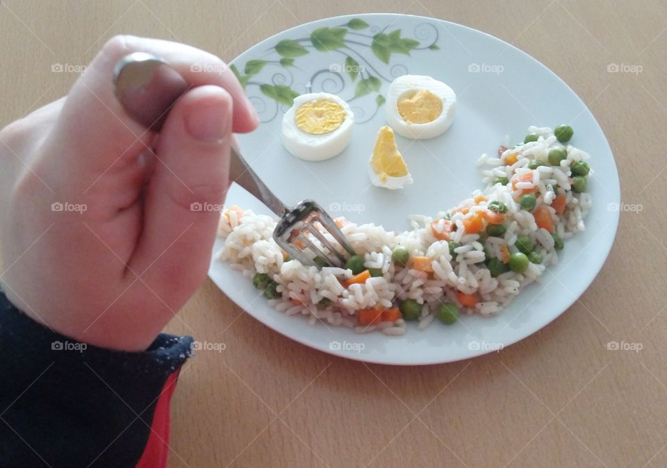 Eating rice and vegetables with eggs.