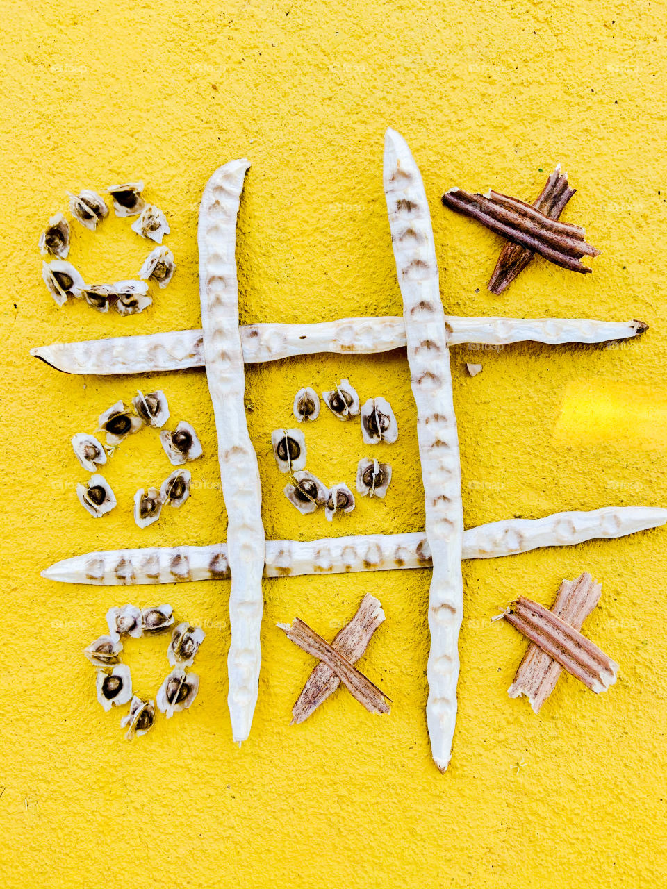 Playing games with seeds in a yellow background 