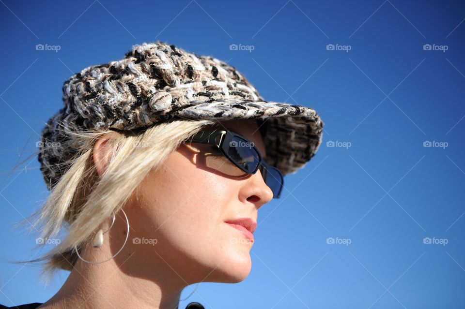 Cute girl in a hat and sunglasses