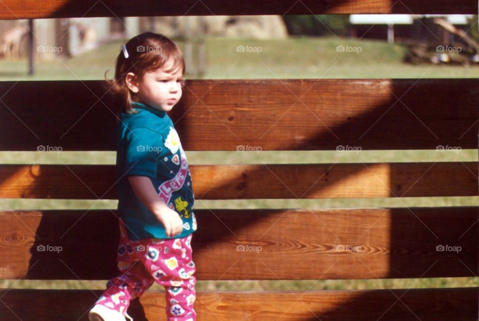 girl by fence