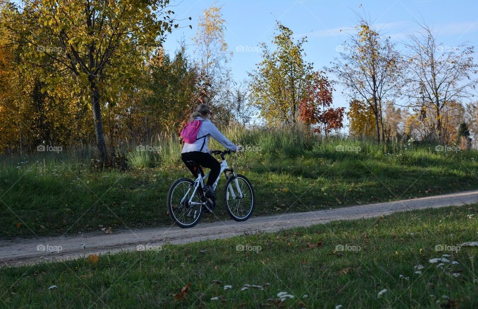 person riding on a bike autumn landscape, social distance