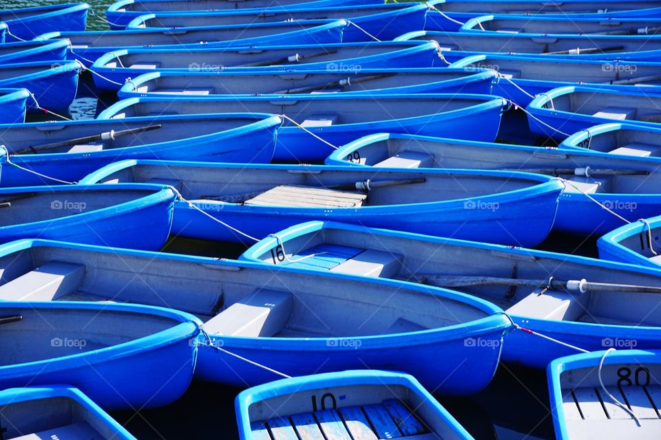 Blue tourist boats moored for the end of season at Arashiyama. 