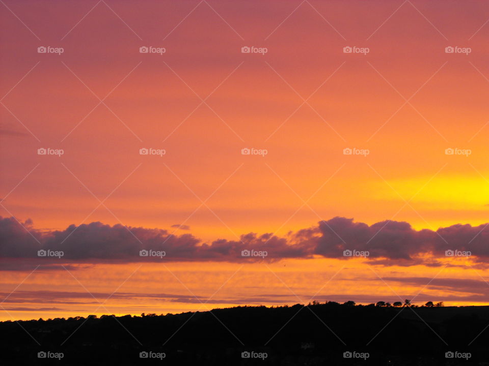An orange sunset sky over