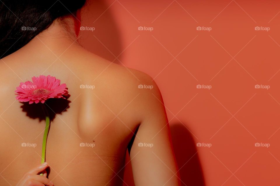 A beautiful young lady holding flower