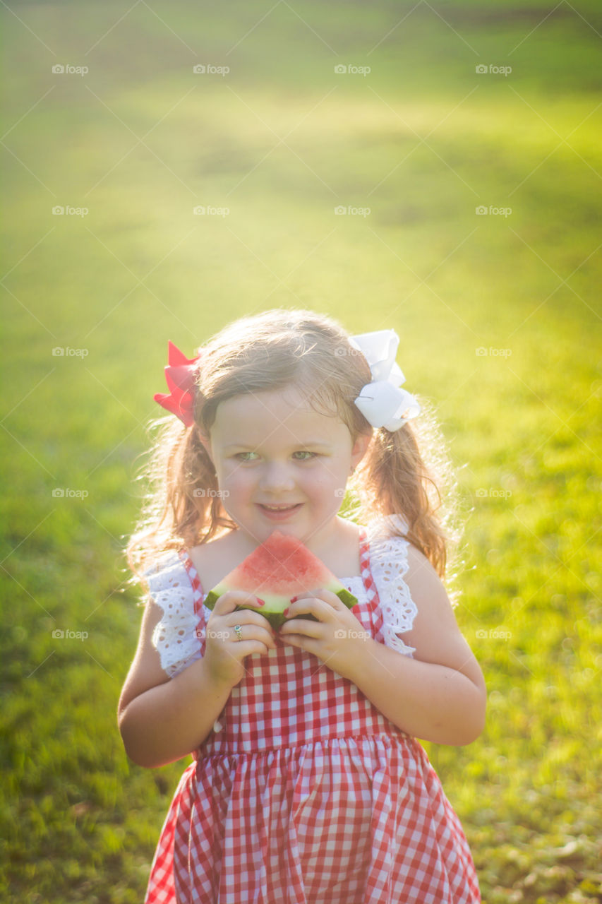 Young Girl Eating Watermelon in the Sunshine 