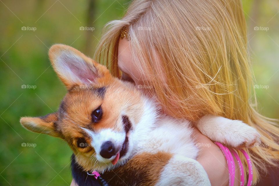 I love you. Girl hugs her puppy