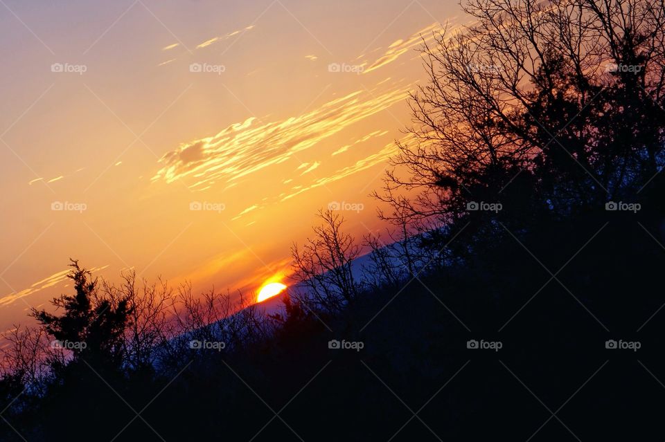 Landscape silhouette with sunset colored sky