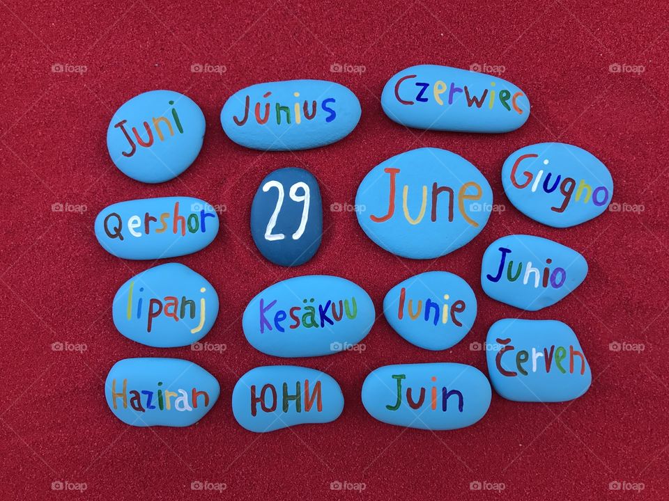 29 June, calendar date in many languages with colored stones and red background 