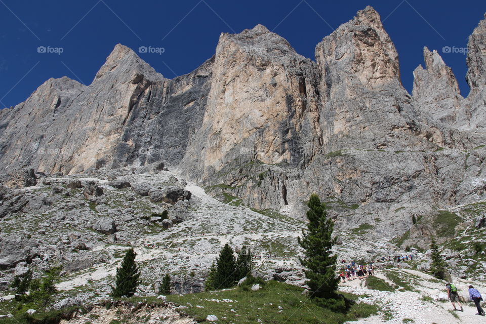 Tourist hiking on mountain slope