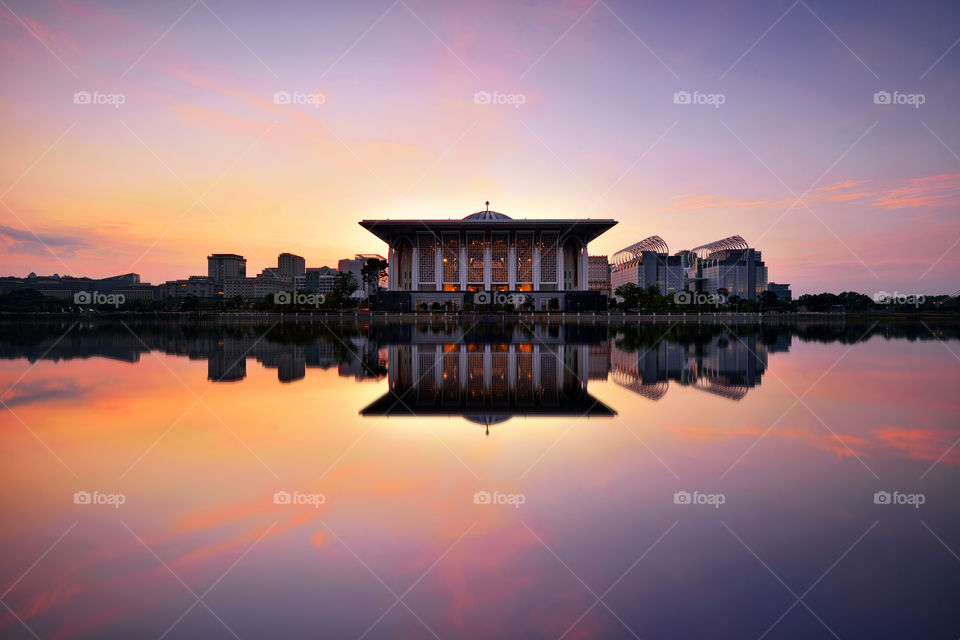 Beautiful reflections of Sultan Mizan Mosque during sunrise