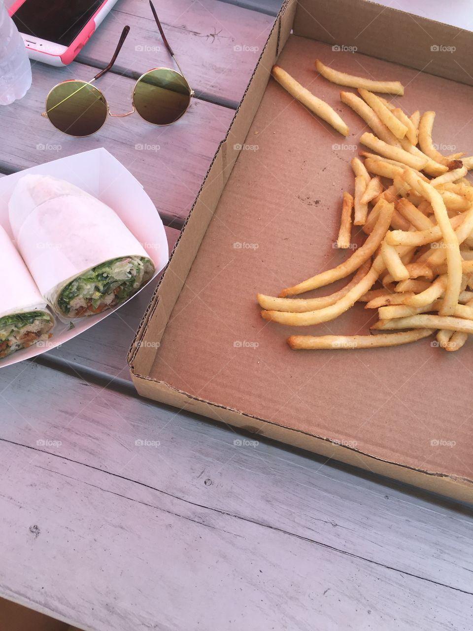 french fries and salad wraps in summer on a beach day