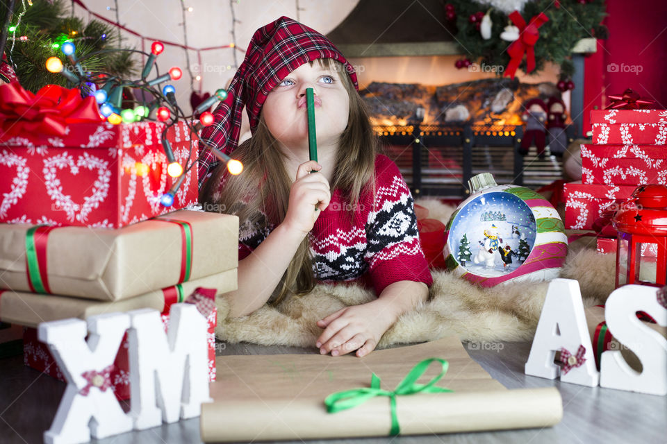 Contemplated girl with christmas presents