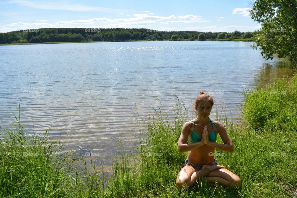 girl training yoga on a lake shore summer time, yoga outdoor