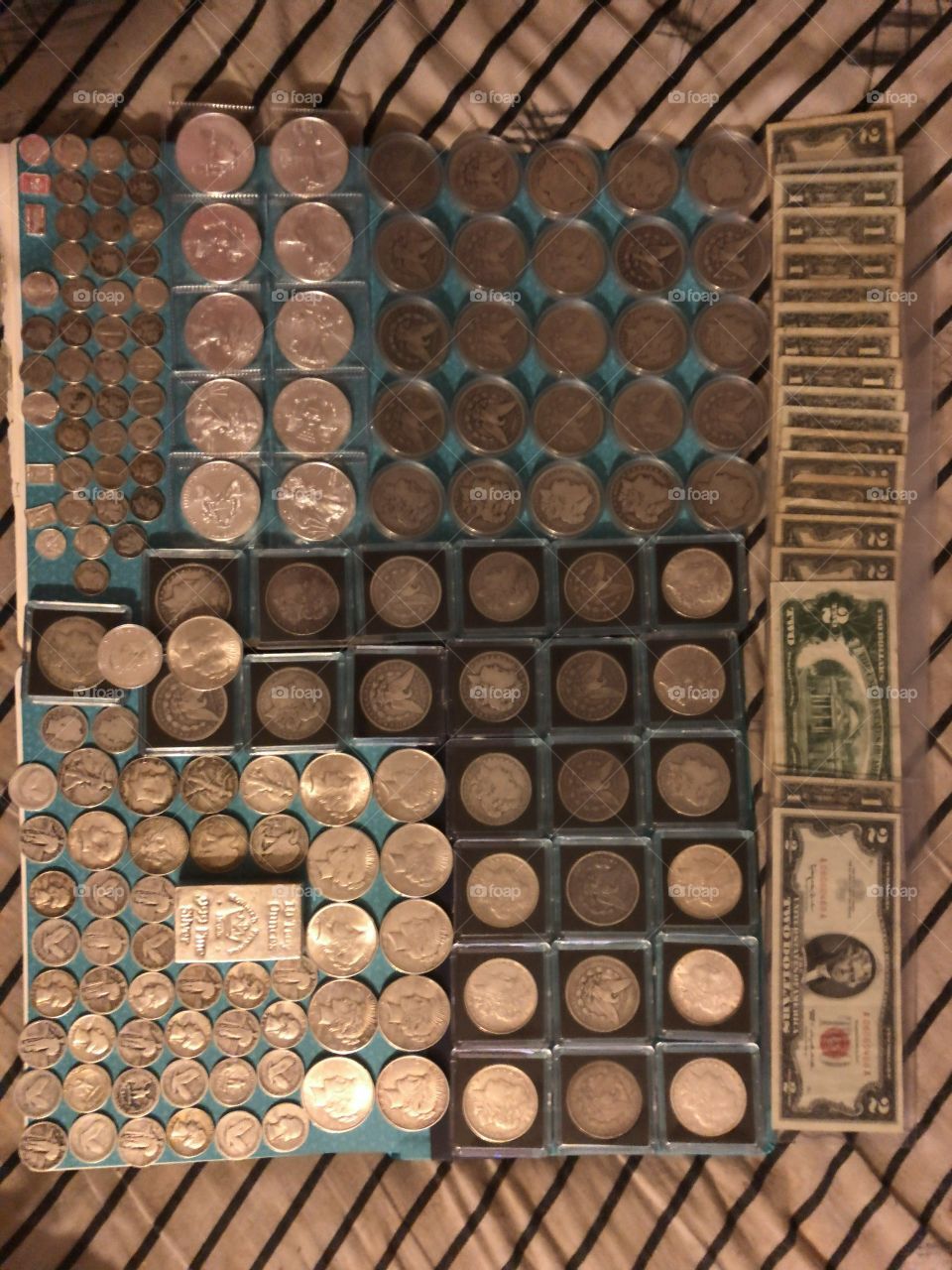 Old world US money such as Morgan silver dollars, peace dollars, old silver coins and paper money like normal green seal two dollar bills and red seal funny back two dollar bills, plus’s quite a few silver blue label one dollar bills. 