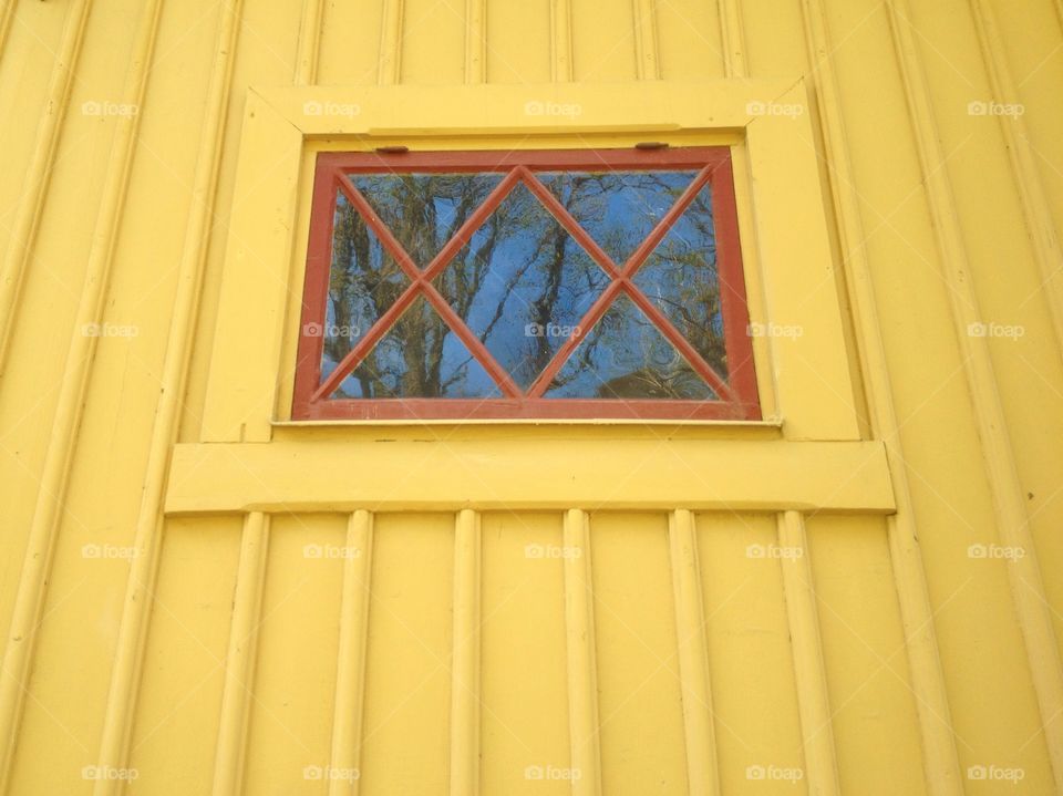 Window on yellow wall