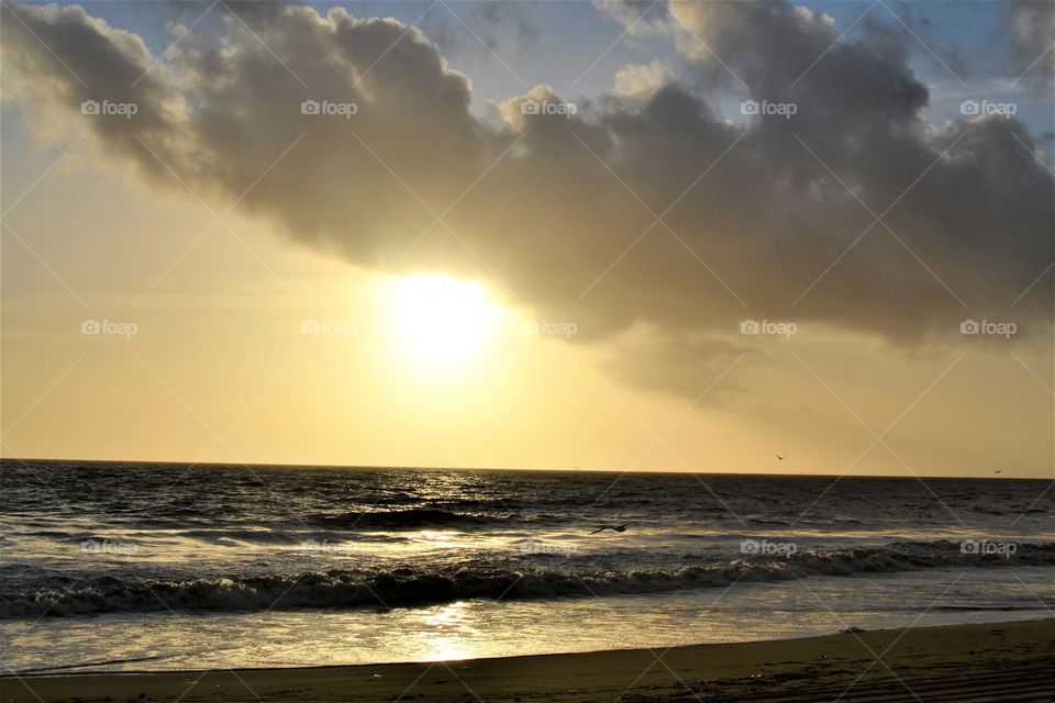 Cloudy evening with sunset on the beach 