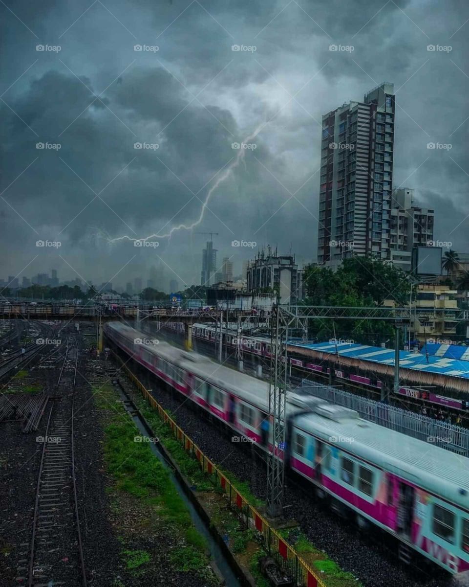 # locomotive# Mumbai# thundering# building# cloudy# train# track# rough weather# Bridge#