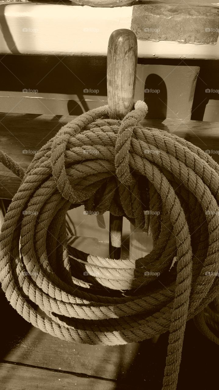 ship's rope or rigging on a wooden belaying pin on a vessal in Monterey Bay