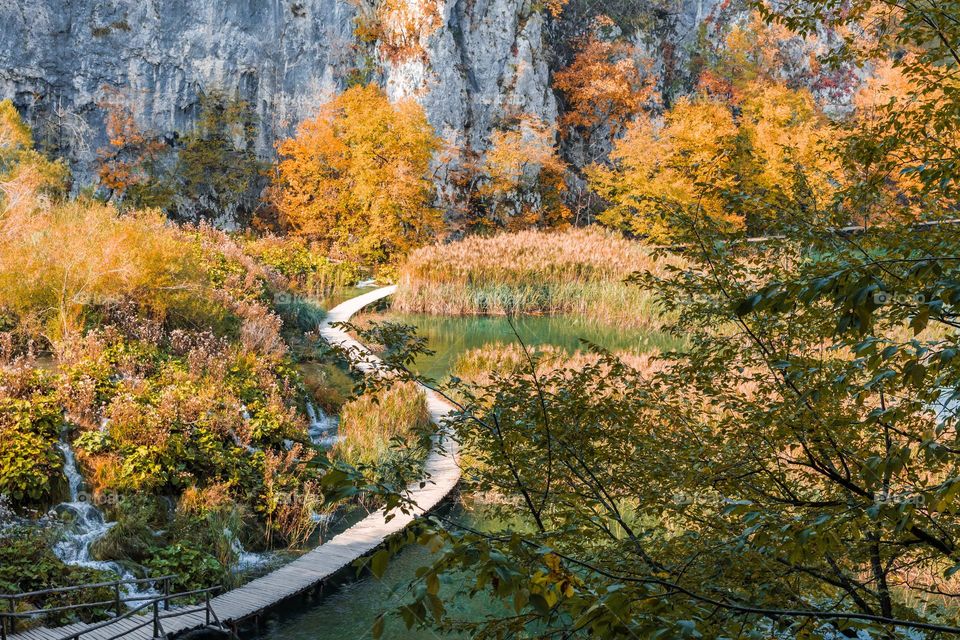 Wooden pathway across lake at Plitvice lakes national park in Croatia in autumn