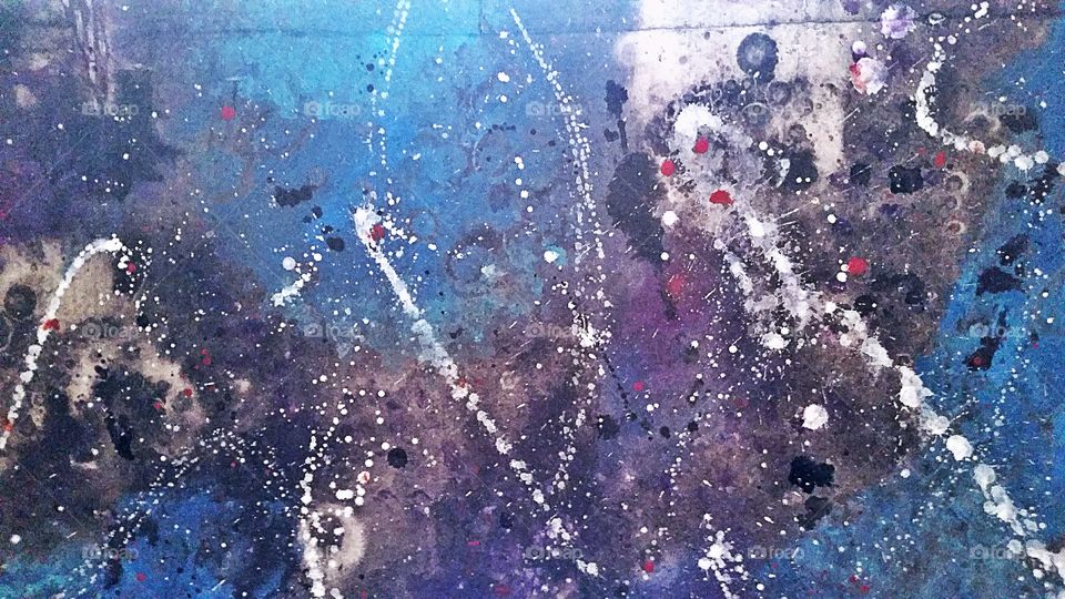 Splattered paint on a concrete wall.