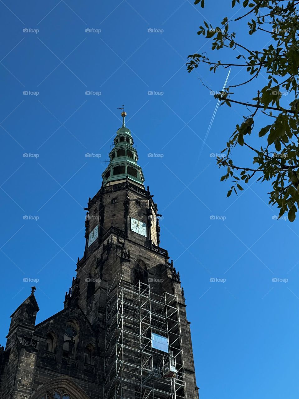Monumental dark cathedral in gothic style, Poland, Świdnica, Lower Silesia. Clear blue sky with a plain in the background. Reconstruction of the old cathedral 