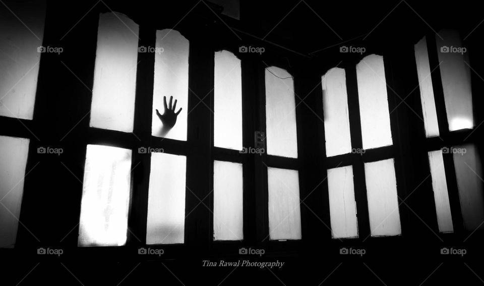 hand in the old home window