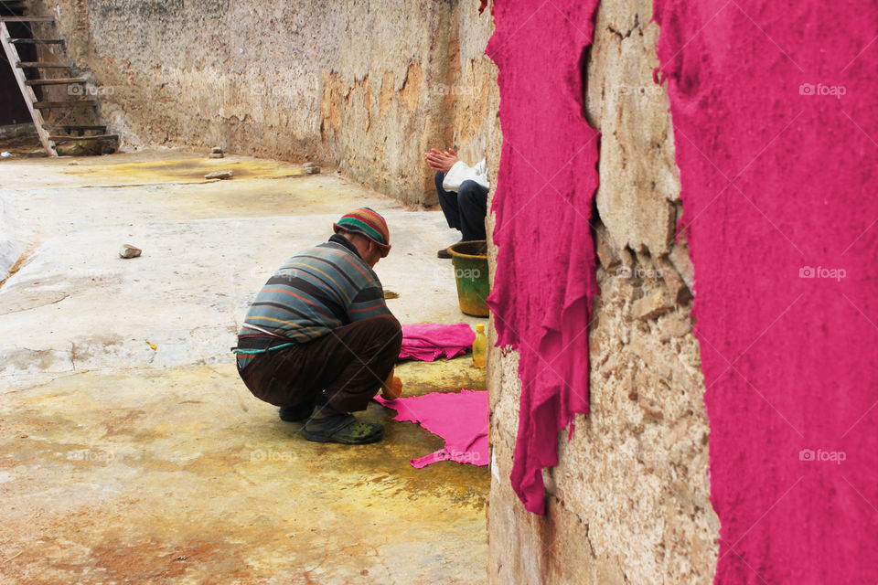man dyeing leather in a tanning on Marocco