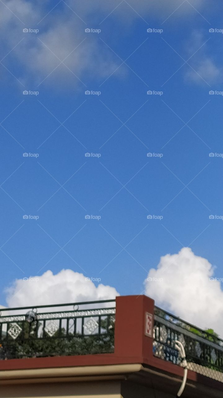 White clouds resting on the roof, look like two big cotton balls