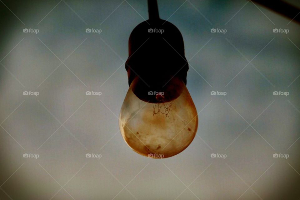 A Light Bulbs Dangles From The Puerto Rican Sky At A Restaurant 