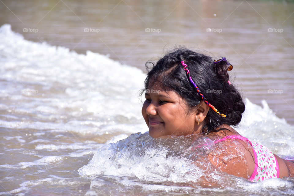 girl enjoying the wave in a beach