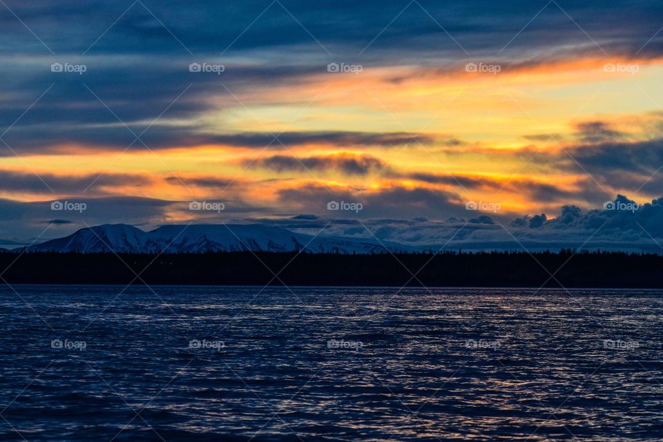 A beautiful cloudy sunset of the Sleeping Lady(Mt. Susitna) down by the port of Anchorage, Alaska
