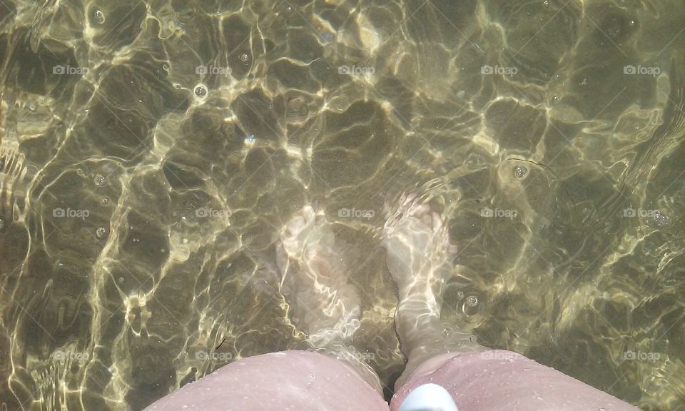 clear water. looking at my feet in the clear ocean water