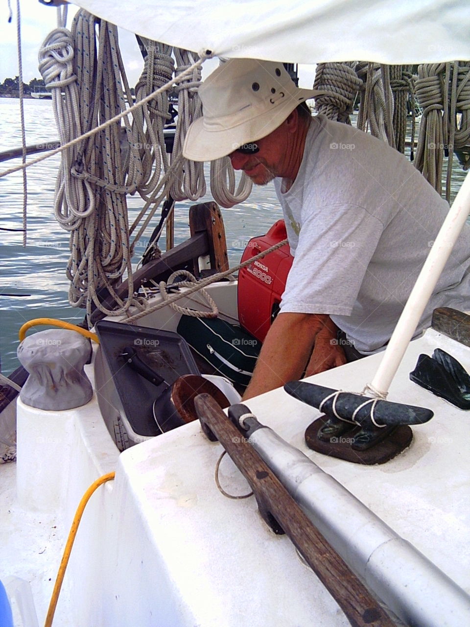 washing the dishes. swabbing the pots and pans in cockpit of sailboat