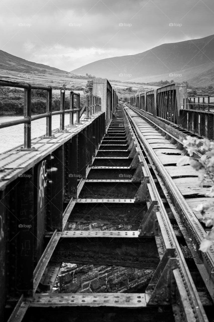 Black and white image of train tracks. Love the lines of this architectural image.