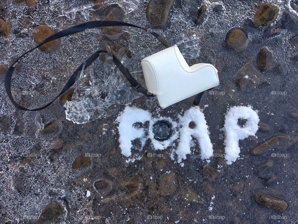 Frozen in the icy river ...foap logo with a camera and lens cover 