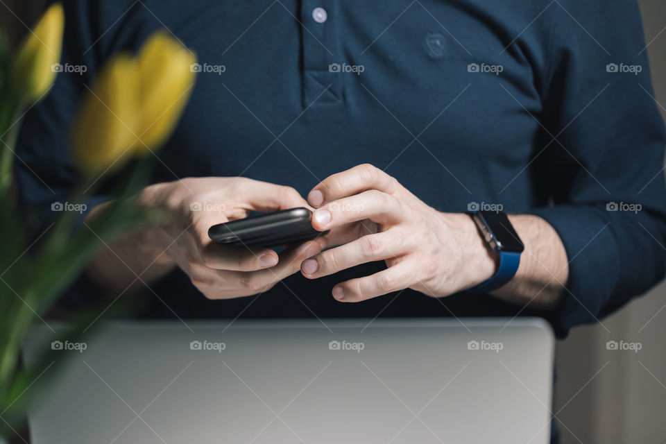 the man uses a mobile phone