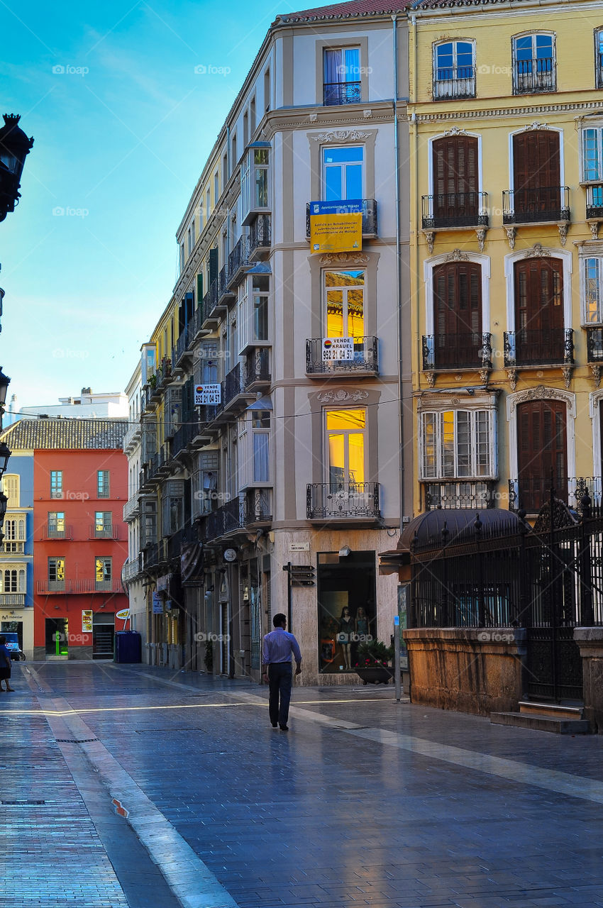 Empty and clean street of Malaga and one person walking on the street