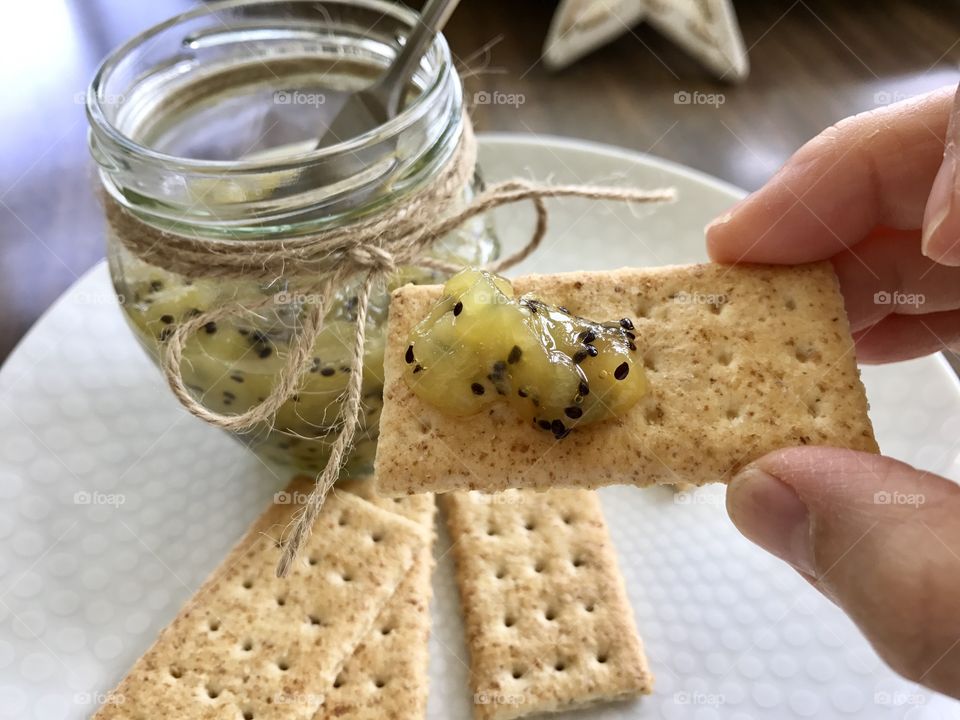 Homemade Kiwi jam and crackers on a plate
