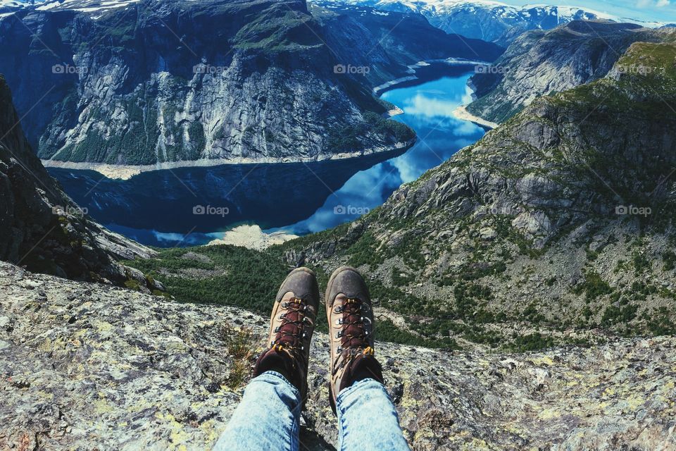 Bright lake at Trolltunga in Norway, feet view from above. 