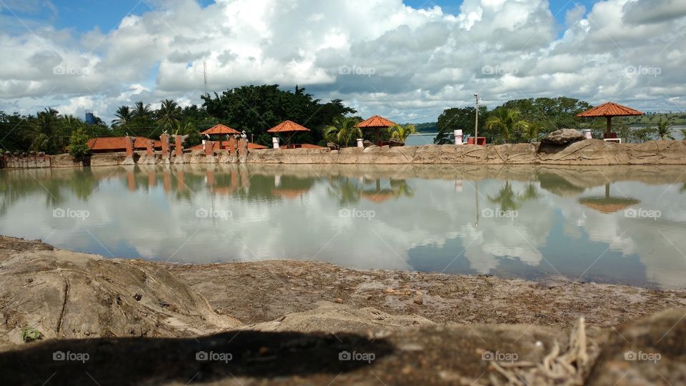 Kiosks and clouds reflected on lake
