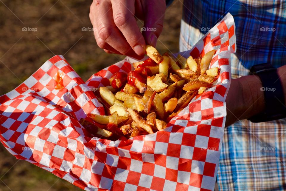 A person eating french fries