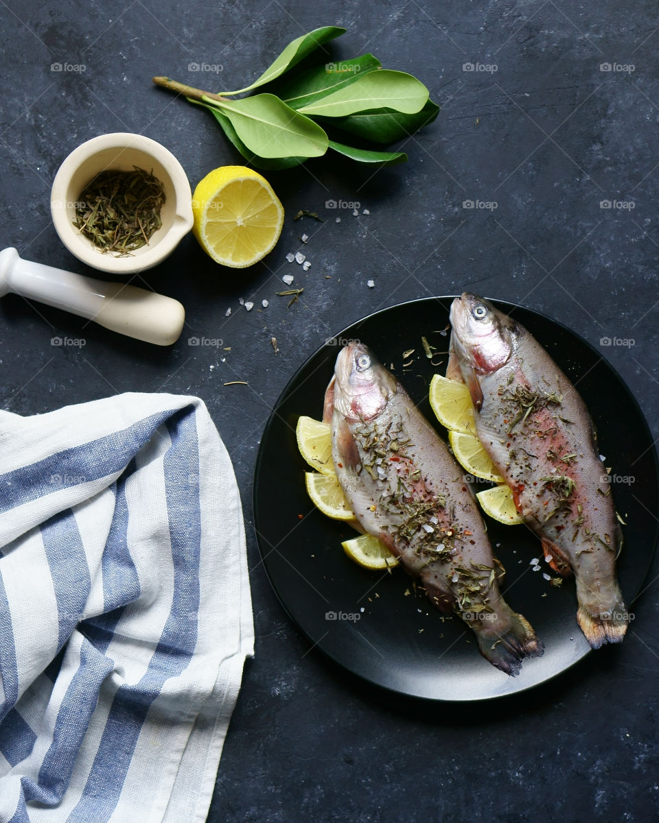 fish, lemon and spices prepared for cooking process