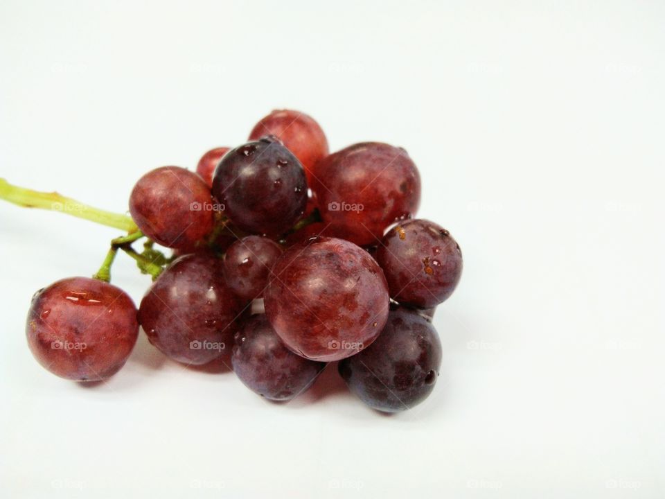 Seedless grapefruit isolated on white background.Water drop on fresh purple grape.