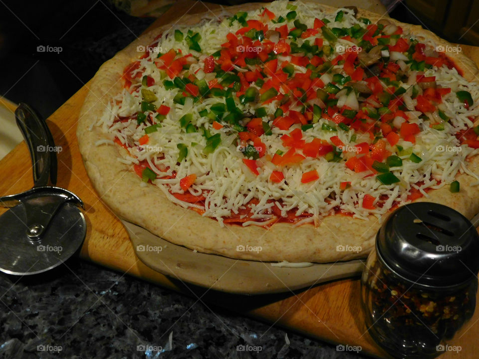 Delicious and nutritious homemade pizza with fresh, colorful vegetables, meats and a variety of spices! Grab a slice!