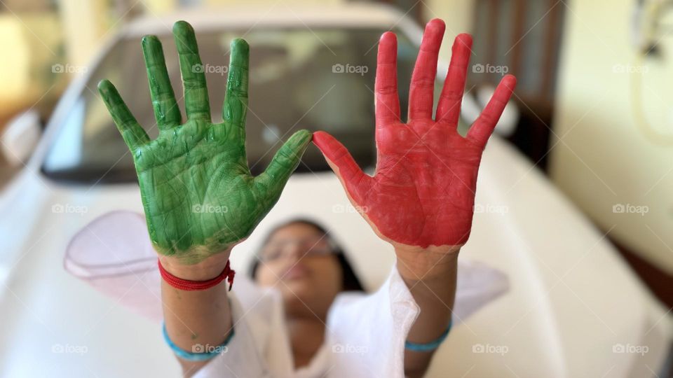 Painted red and green hands.